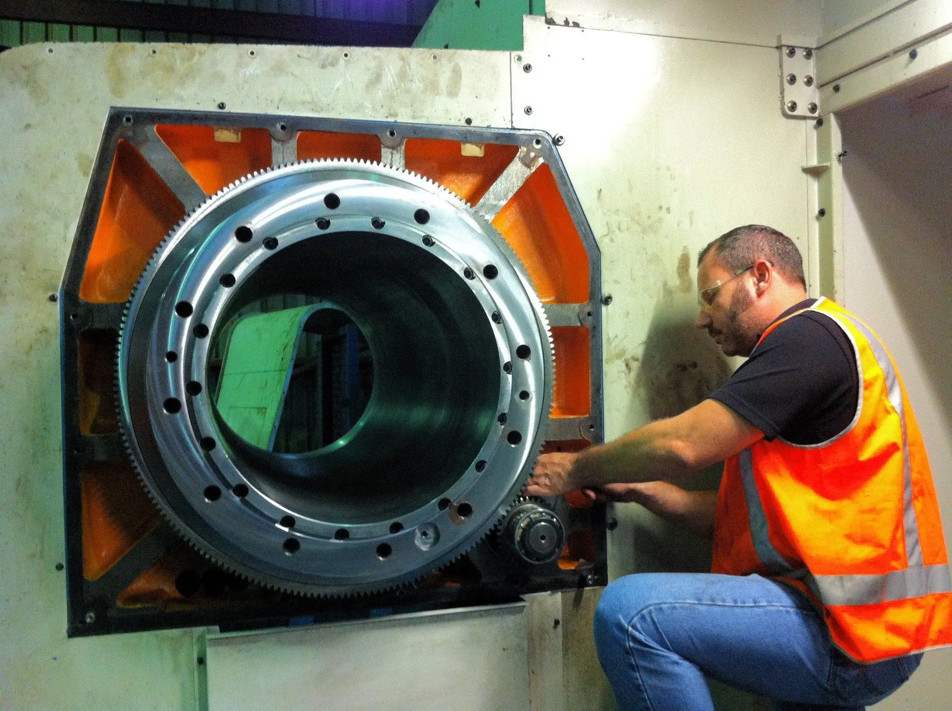 CNC Machinery service engineer fitting a large rotary table ring gear on site